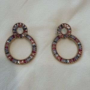 Multi colored rhinestone look hoop earrings.